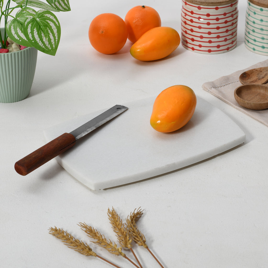 Rectangle marble chopping board with curved sides.