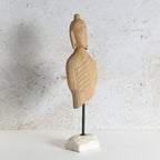 Carved wooden Buddha bust sculpture mounted on a black metal stand with a white marble base.