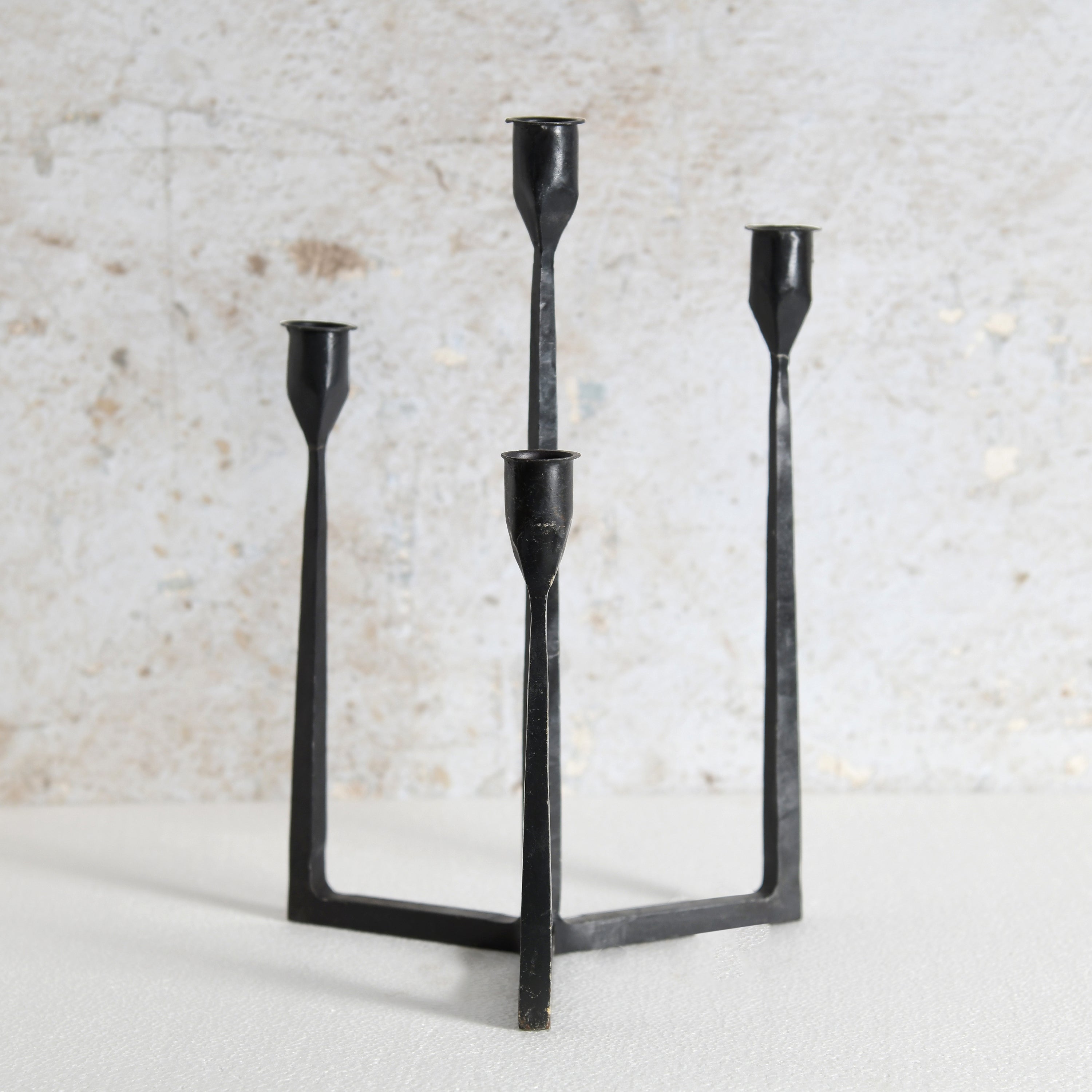 A black metal three-light candelabra with a minimalist, geometric design. Premium Home Decor