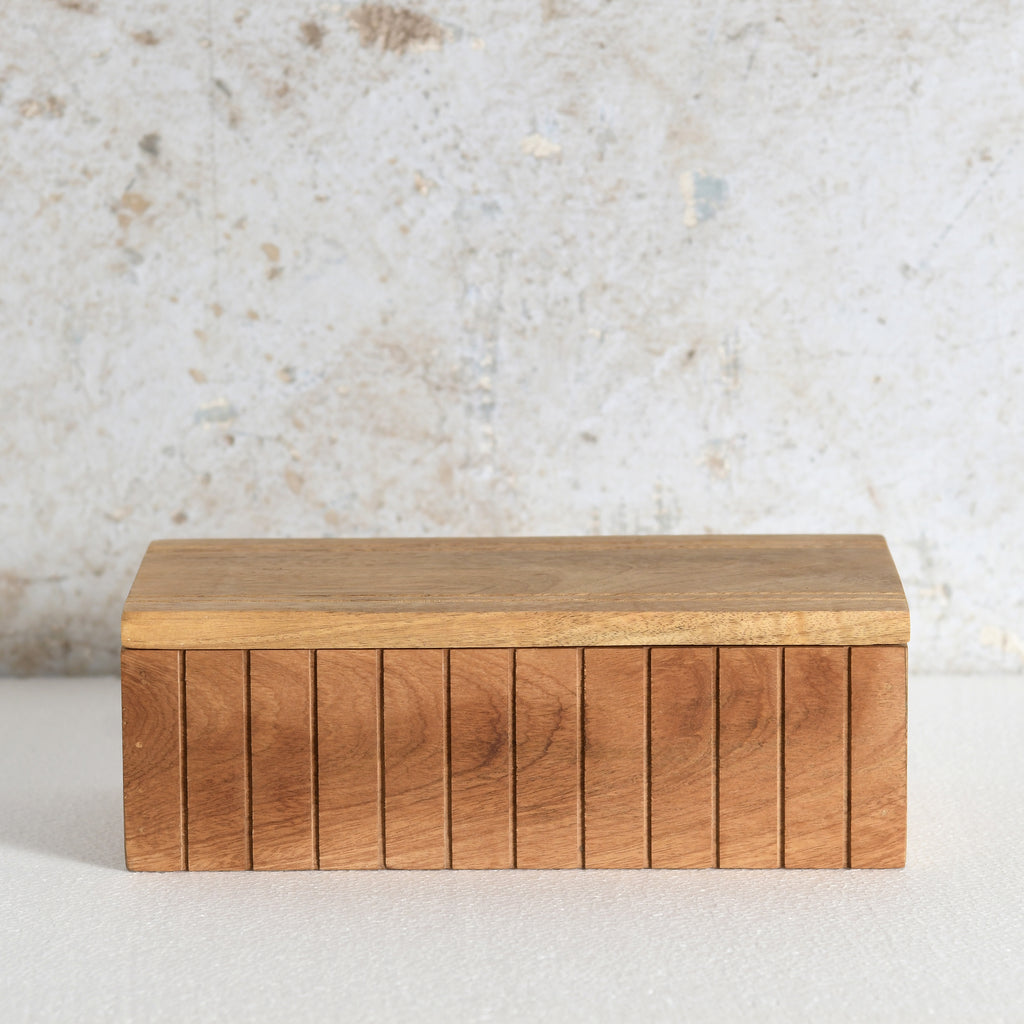 A rectangular wooden box with a slatted front and a flat lid.