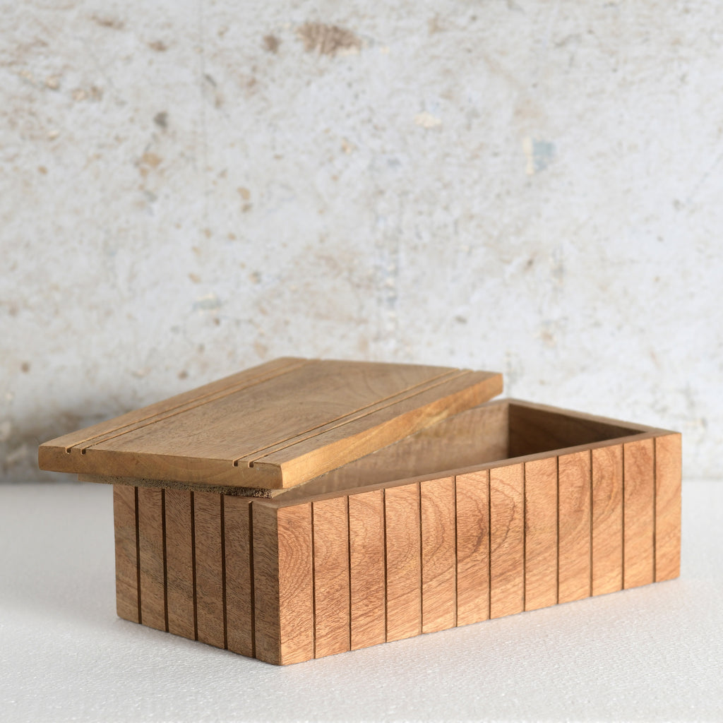 A rectangular wooden storage box with a slatted front and lid.