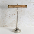 A vintage-style Jewellery Stand with polished silver metal stand and a natural wood T-bar shade, accented with brass caps on the ends.