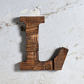 A rustic wooden letter 'L' wall decor piece with a dark brown stained finish and visible wood grain with a hook for hanging.