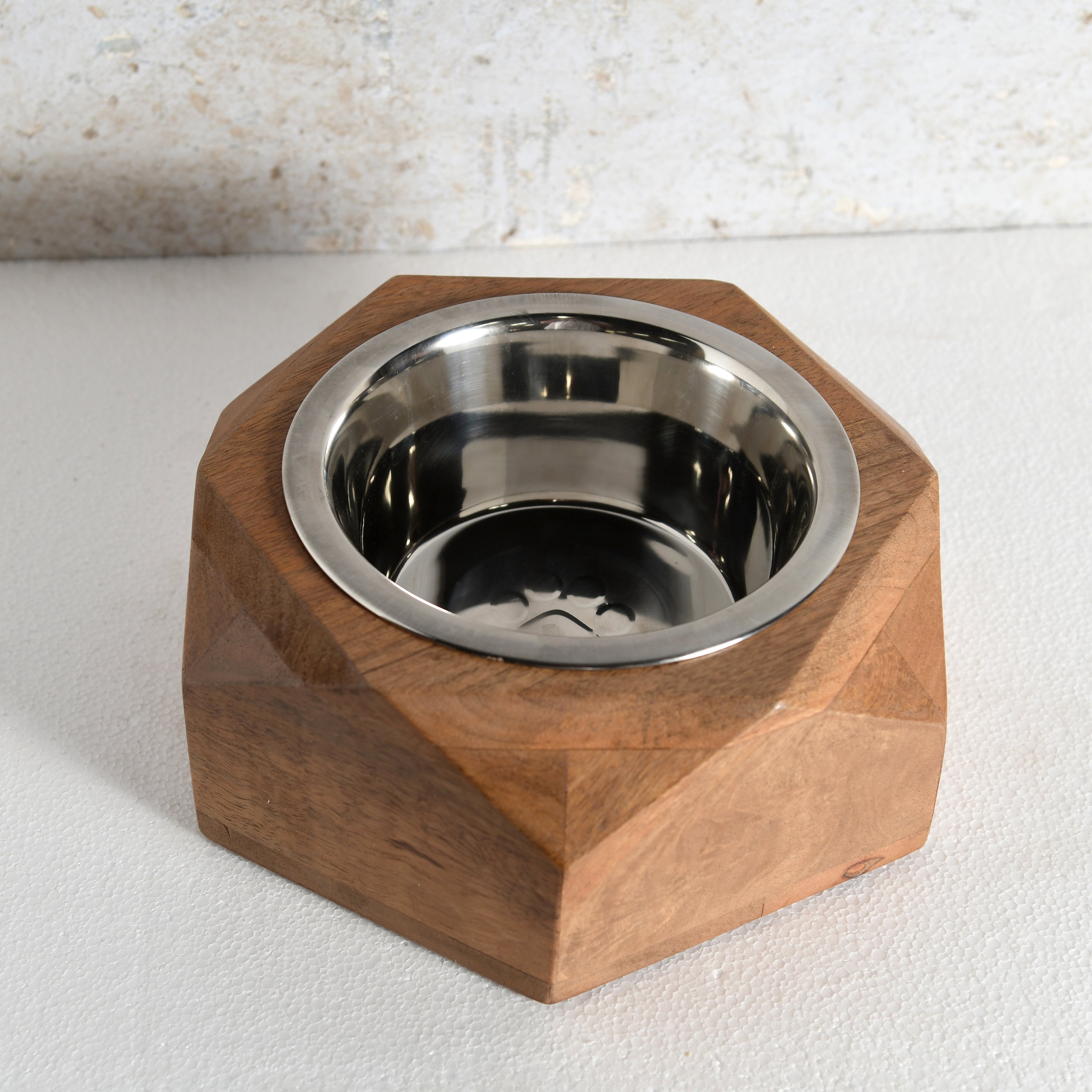 A faceted octagonal wooden pet feeder bowl with a stainless steel interior.