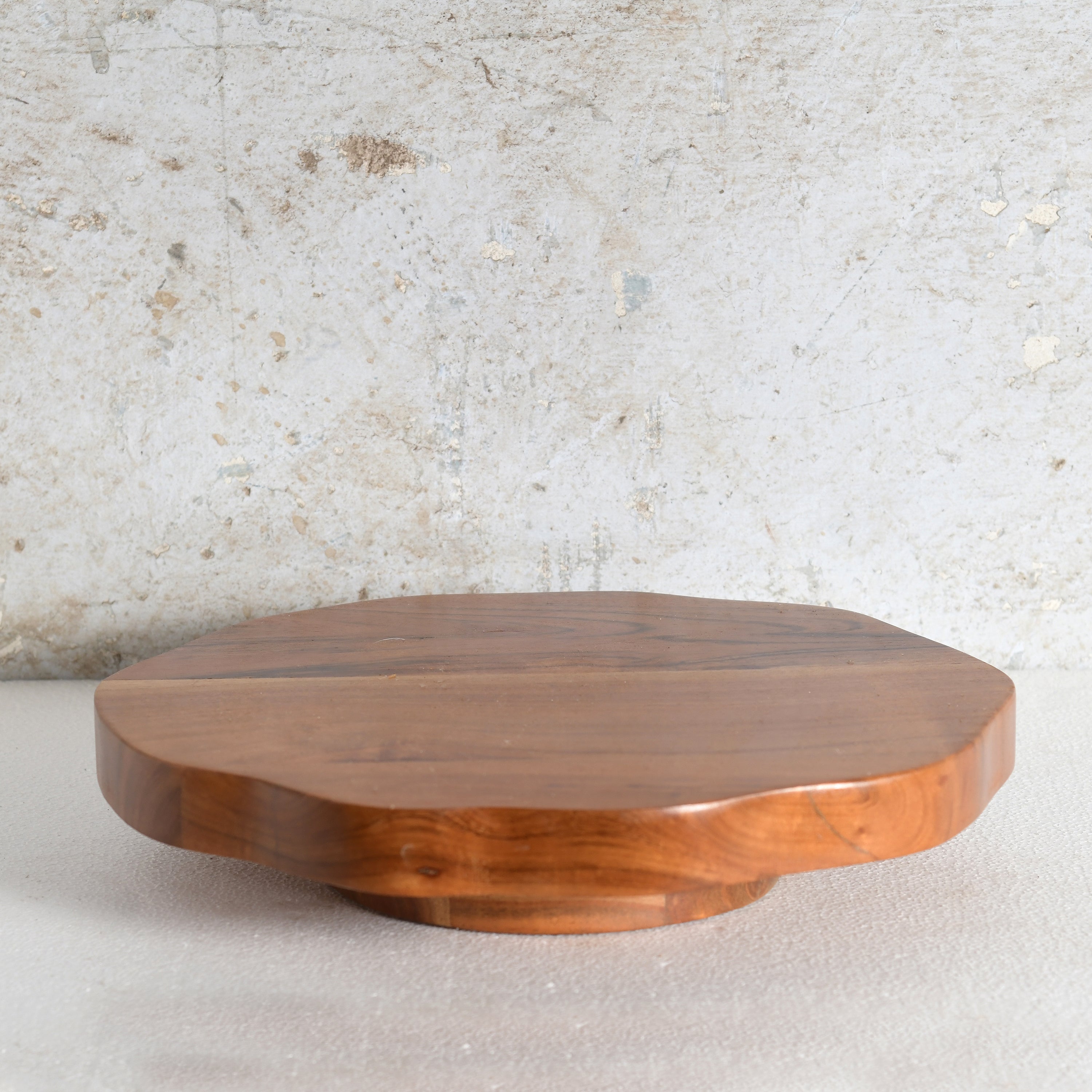 A round wooden serving board | Lazy Susan scalloped edge, made from medium brown wood.