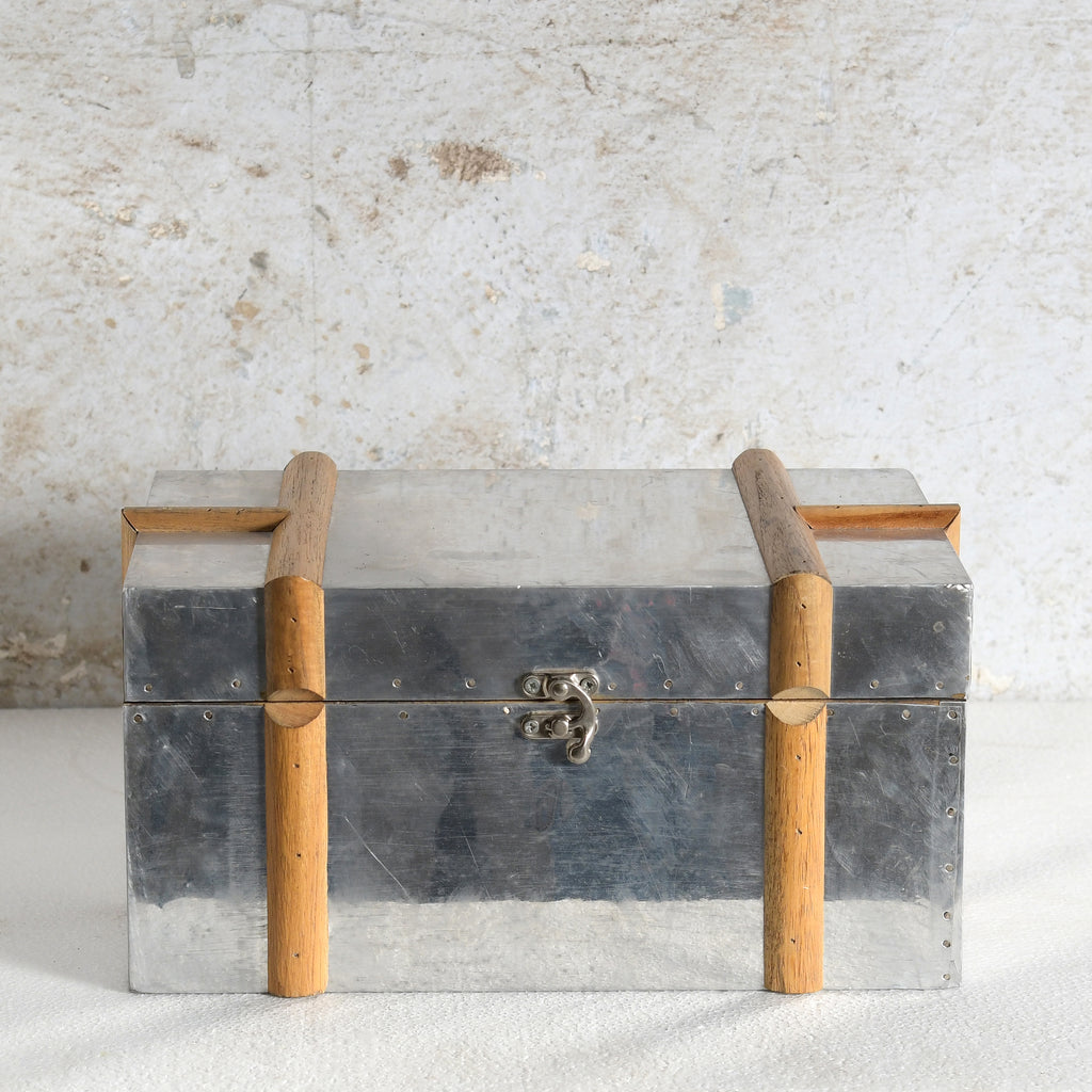 A vintage-style metal storage chest with a brushed silver-gray finish.