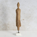 Wooden monk figure with white marble base.