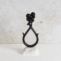 Iron showpiece in black finish with white marble base.