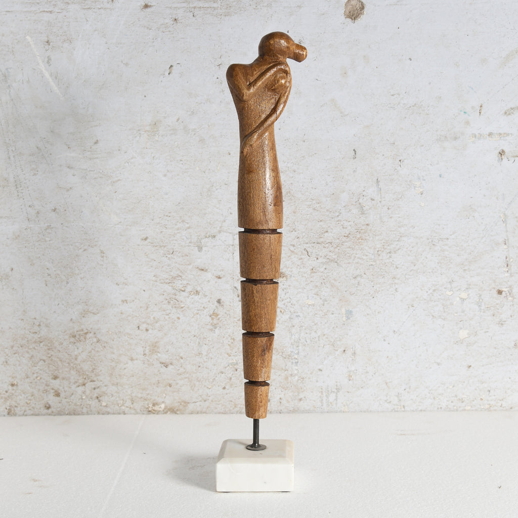 Mango wood sculpture with white stone base