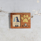 Wooden photo frame with a  paw print and a small hook mounted on plyobard