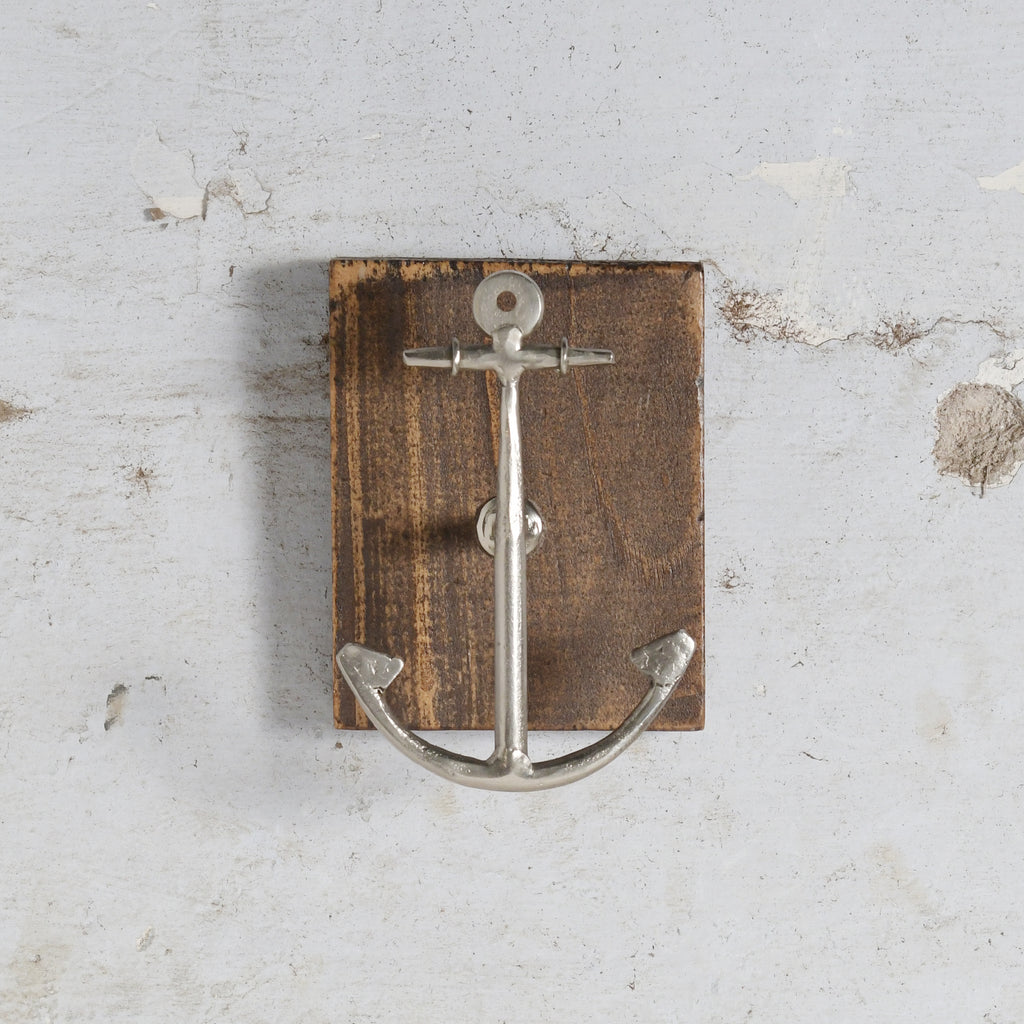 Anchor-shaped wall hook on wooden block 