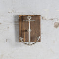 Anchor-shaped wall hook on wooden block 