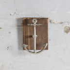 Anchor-shaped wall hook on wooden block 
