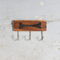 Wooden wall hanger with bone impresion