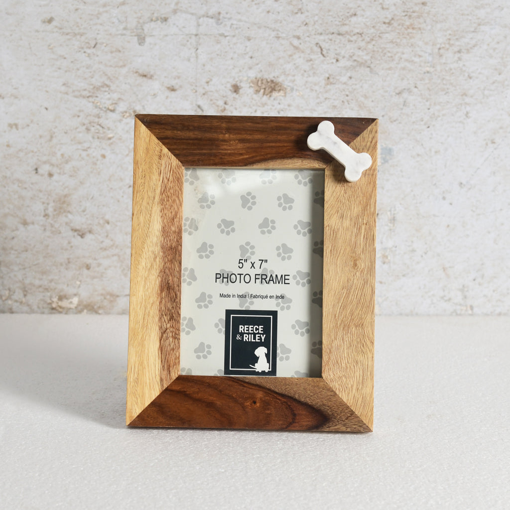 Wooden photo frame with a bone-shaped decorative element