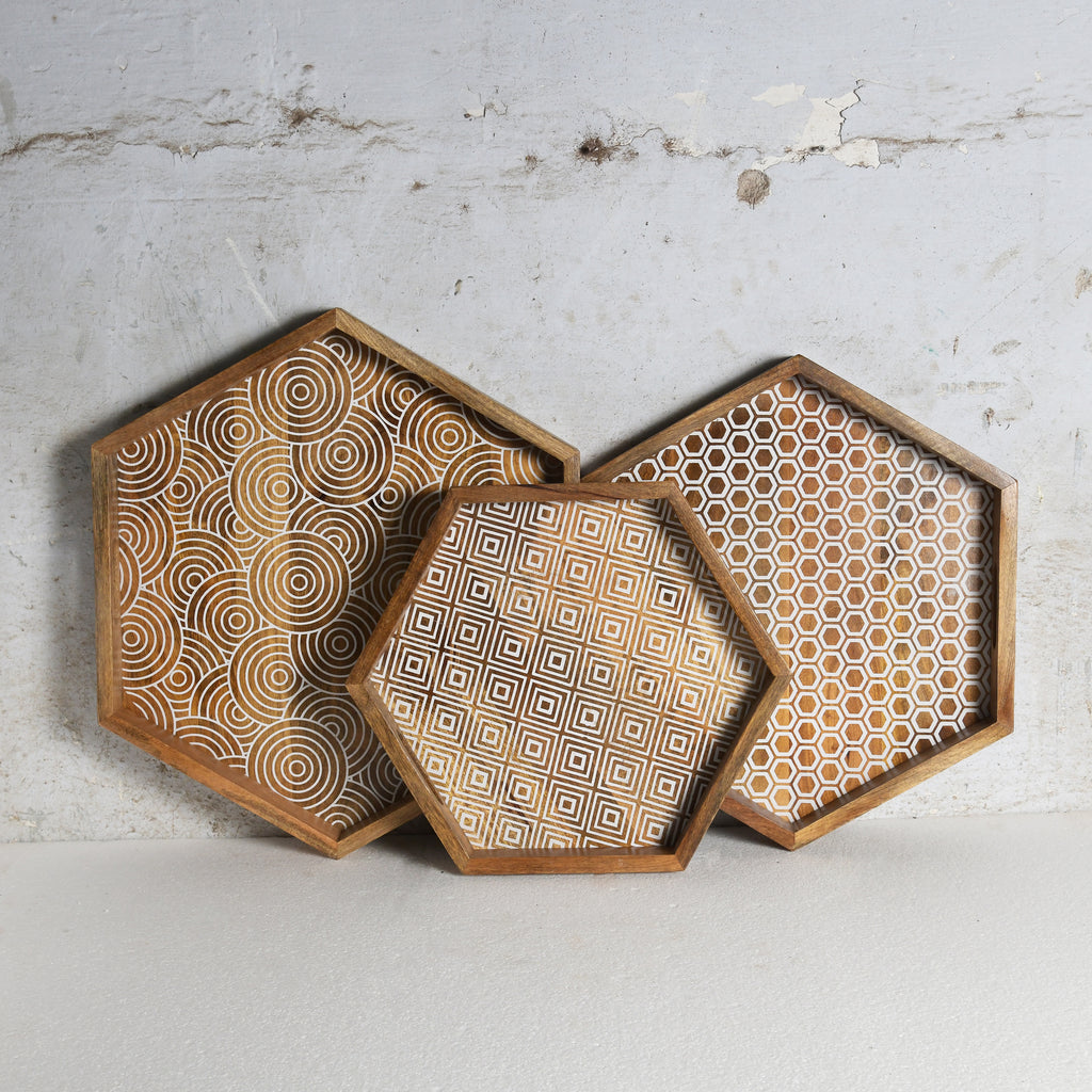 Set of three hexagon shaped wooden trays with geometric pattern detailing
