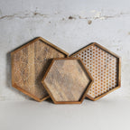 Set of three hexagon shaped wooden trays with geometric pattern detailing