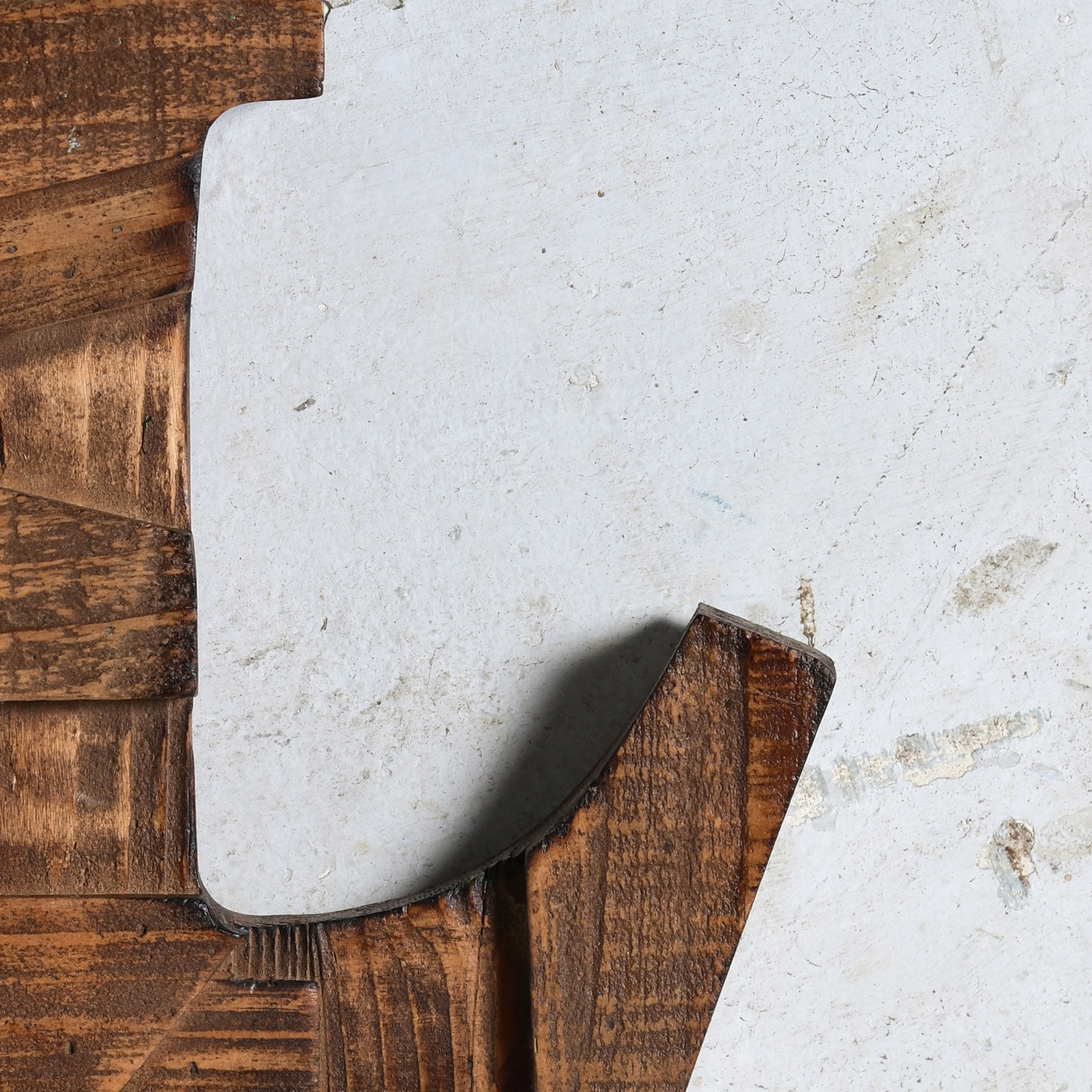 A close-up of a decorative Alphabet with a distressed, irregular shape, a dark brown wooden frame with visible grain and texture in Pine Wood.