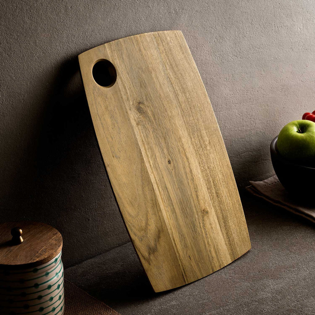 Acacia wood rectangle chopping board with curved sides.
